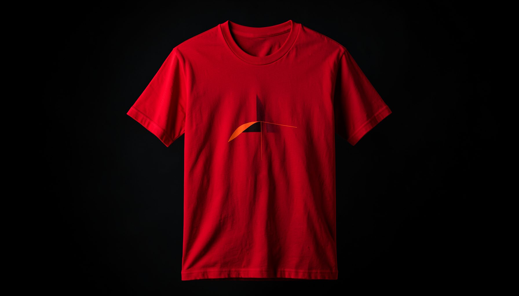 A bold red t-shirt with a minimalist graphic, photographed against a dark studio backdrop with dramatic lighting
